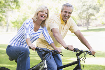 senior citizen couple riding bike