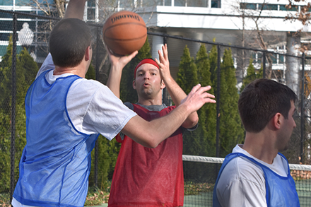 IDA staff members playing basketball during March Madness tournament