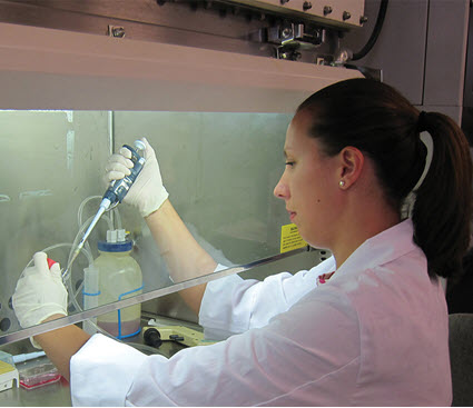 Photo, scientist working with dropper behind glass